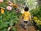 Little Asian baby girl enjoys walking in a flora garden