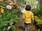 Little Asian baby girl enjoys walking in a flora garden