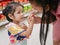 Little Asian baby girl feeding her mother a potato chip - children learn to give