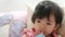 Little Asian baby girl getting drowsy while drinking milk - baby`s self soothing