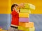 Little Asian baby girl stacking up foam building bricks / blocks at an indoor playground