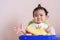 Little Asian baby girl unhappy face in dining time, sadness, baby expression concept