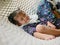 Little Asian baby girls enjoys lying down on a hammock with together with her older sister at home