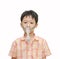 Little Asian boy with asthma using oxygen mask on white backgro