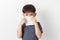 Little asian boy holding a tissue and blow his nose. Kid with cold rhinitis. virus and infection. Coronavirus symptom