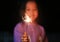 Little Asian child girl enjoy playing firecrackers. Focus at fire sparklers