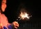 Little Asian child girl enjoy playing firecrackers. Focus at fire sparklers