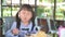 Little asian child girl having breakfast at the morning with a happy smiling face