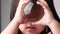 Little Asian child girl holding and look into a magic crystal glass ball in room.