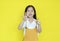 Little asian child girl showing finger number seven isolated on yellow background. Kid counting with fingers for education concept