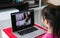 Little asian girl attending to online e-learning platform class from home while school has been closed during coronavirus outbreak