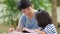 Little Asian girl with father doing homework