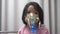 Little Asian girl having an oxygen mask and breathing through a nebulizer at the hospital. Concept of bronchitis, respiratory and
