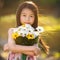 Little asian girl holding a bunch of flowers