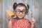 Little asian girl holding and enjoying peanut butter in jar and a spoon