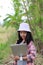The little Asian girl holding tablet at the tropical farm, Little famer smile