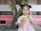 Little Asian girl peeling banana