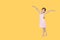 Little asian girl in pink leotard practise her ballet dance isolated on orange-yellow background with copy space. Children is