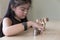 little asian girl put coin to money stack - money saving education concept