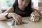 little asian girl put coin to money stack - money saving education concept