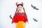 Little asian girl in red devil dress in halloween decorated room