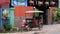 Little Asian girl sits in a moto rickshaw near a house with red lanterns