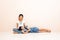 Little asian girl sitting with her old sister on floor at home. lovely relation.