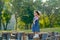 Little Asian girl stand on timber and look fun with playing in park or garden