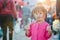 Little asian girl walking on street of Bangkok, buy barbeque and eating street food in evening time