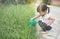 Little asian girl watering plants