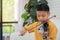 A Little Asian kid playing and practice violin musical string instrument against in home, Concept of Musical education,