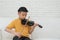 A Little Asian kid playing and practice violin musical string instrument against in home, Concept of Musical education,