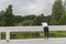 Little asian kids stand on the bridge, leaning on the fence