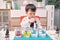 Little Asian kindergarten kid studying science, making Sugar Water Density Experiment, Kid-friendly fun and easy science