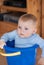 Little baby boy in blue bucket indoor