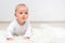 Little baby boy crawling on the floor and smiling, baby and white background