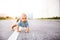 Little baby boy crawling outside on the road.