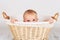 Little baby boy hiding inside the wicker basket