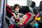 Little baby boy and his older brother, traveling in car seats, g