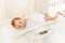 Little baby boy lay on scale for measuring body