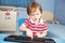 Little baby boy typing on computer keyboard