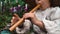 Little baby fingers playing on wooden little flute. Close up view of caucasian children`s fingers playing on music instrument