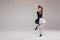 Little baby girl ballerina dancing in black and white clothing smiling having positive emotion