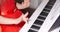 Little baby girl or child professional pianist plays classical music on a beautiful white piano a Christmas holiday