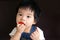 Little baby girl eating strawberry
