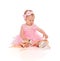 Little baby girl in a pink ballerina dress with pointe shoes