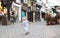 Little baby girl running in a beautiful street