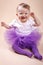 Little baby girl sitting in tutu skirt