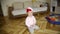Little baby girl very funny dancing and moving in rhythm of music wearing very funny hat