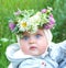 little baby girl wearing flowers and herbs crown in solstice night